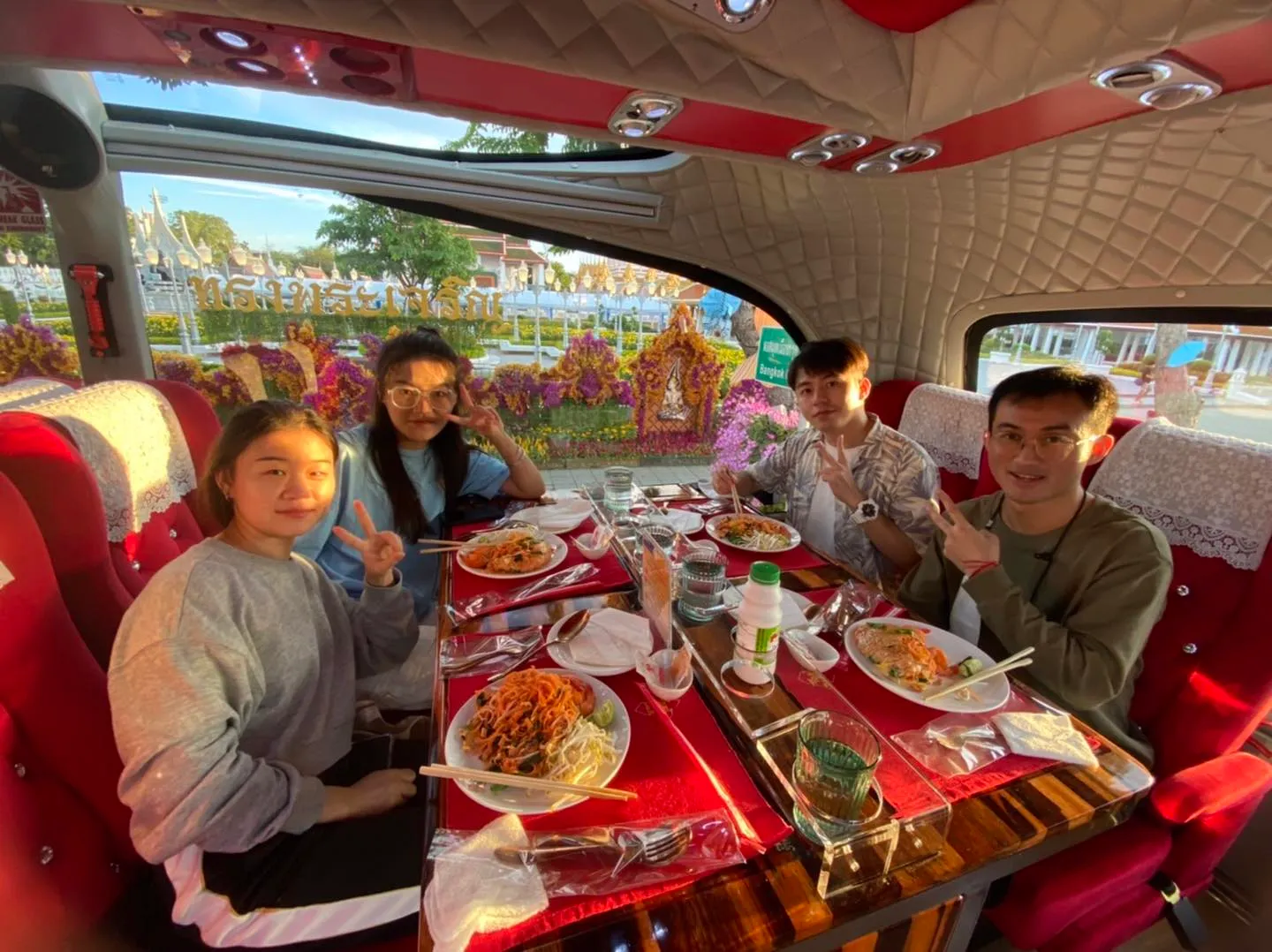 Young female guests eating with panoramic Bangkok city and river view during daytime tour