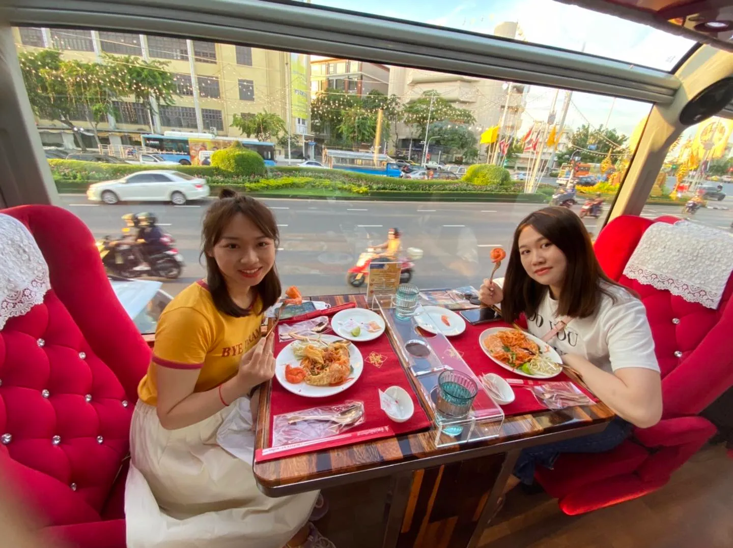 Elegant afternoon tea service with tiered stand, white teapot, and palace gardens view