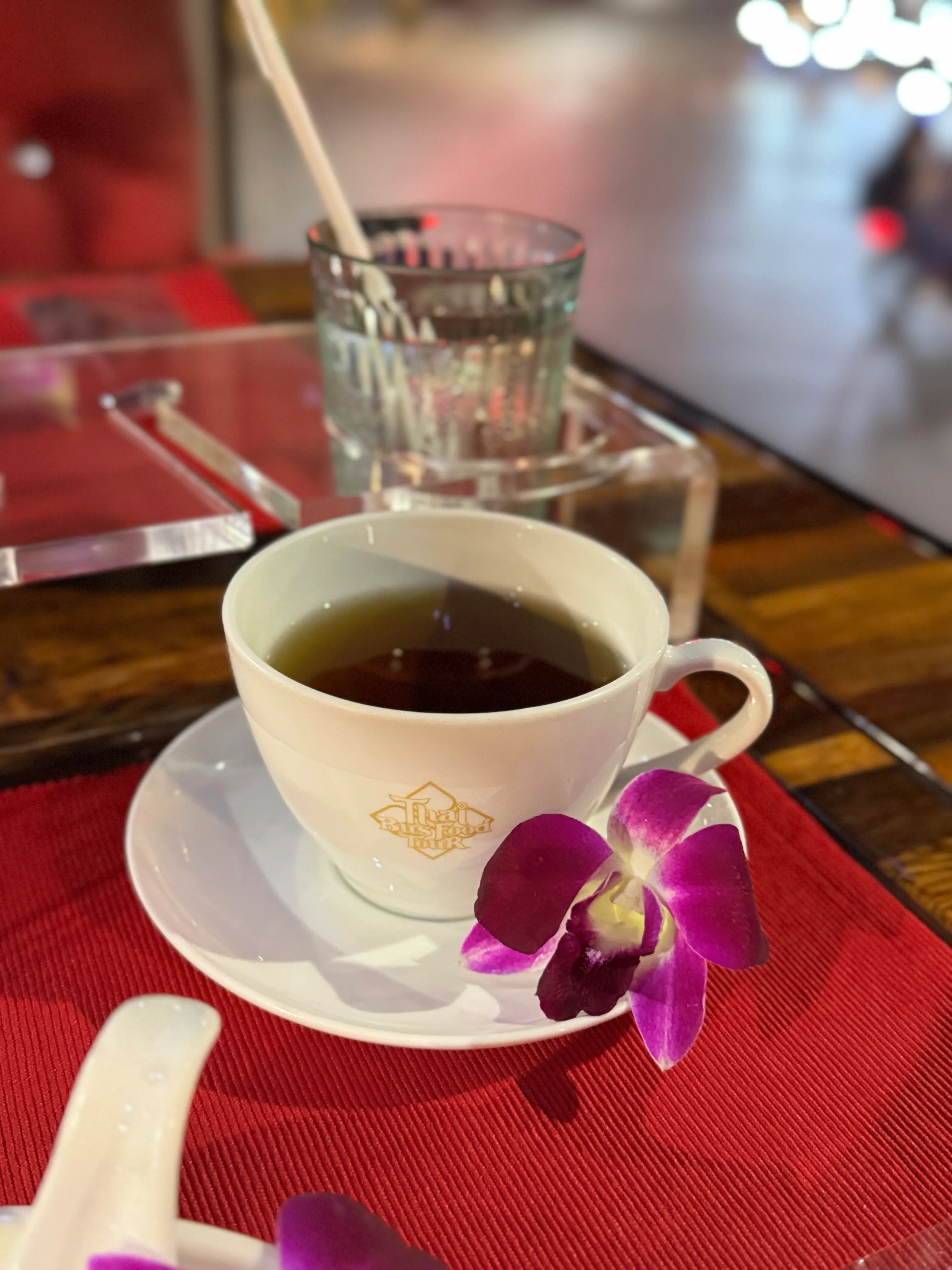 Group of guests enjoying meal together inside bus with elegant red and gold interior