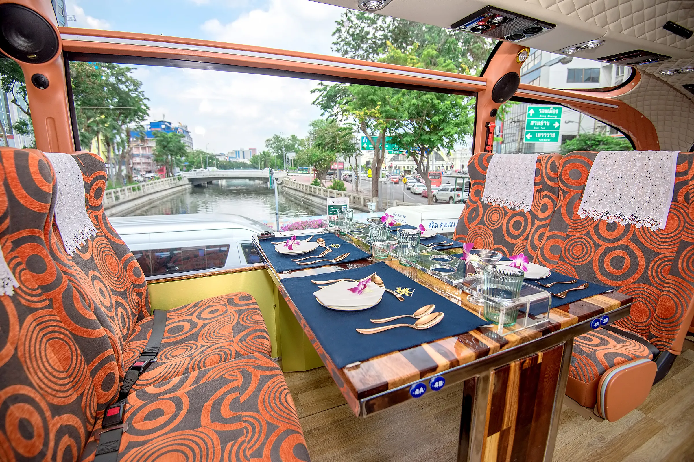 Michelin street food set with wok-fired pad thai served on the Thai Bus Food Tour, with the Giant Swing landmark visible through the window